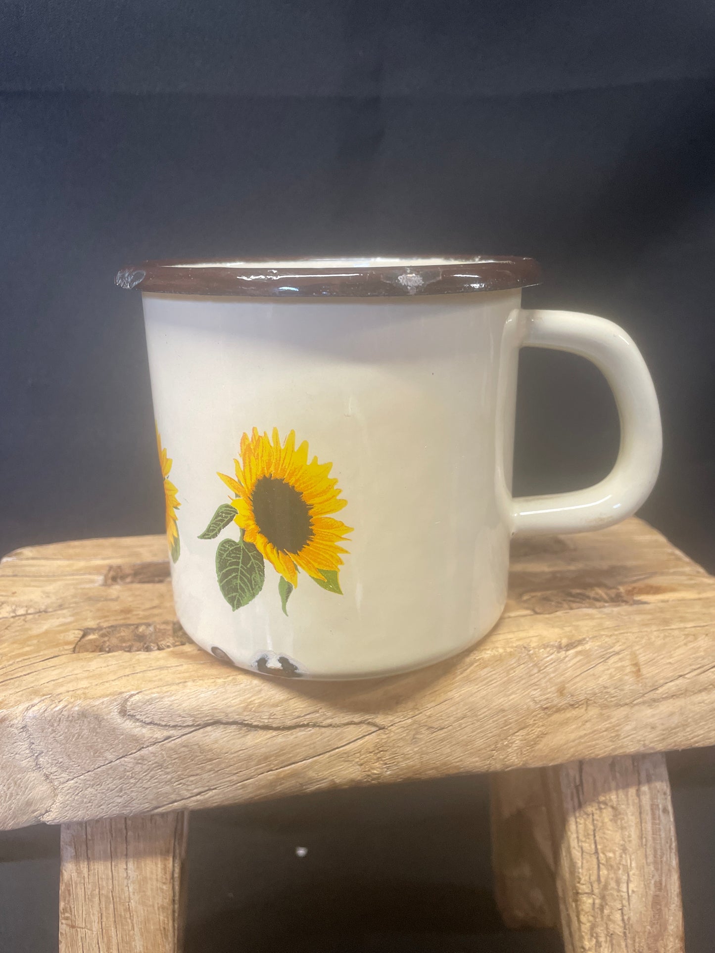 Large cream enamel mug with sunflowers decor.