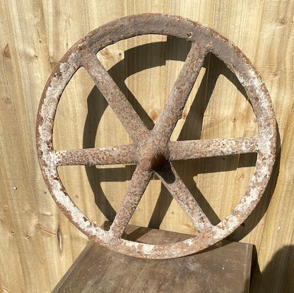Antique cast iron barrow wheel rustic garden decor.
