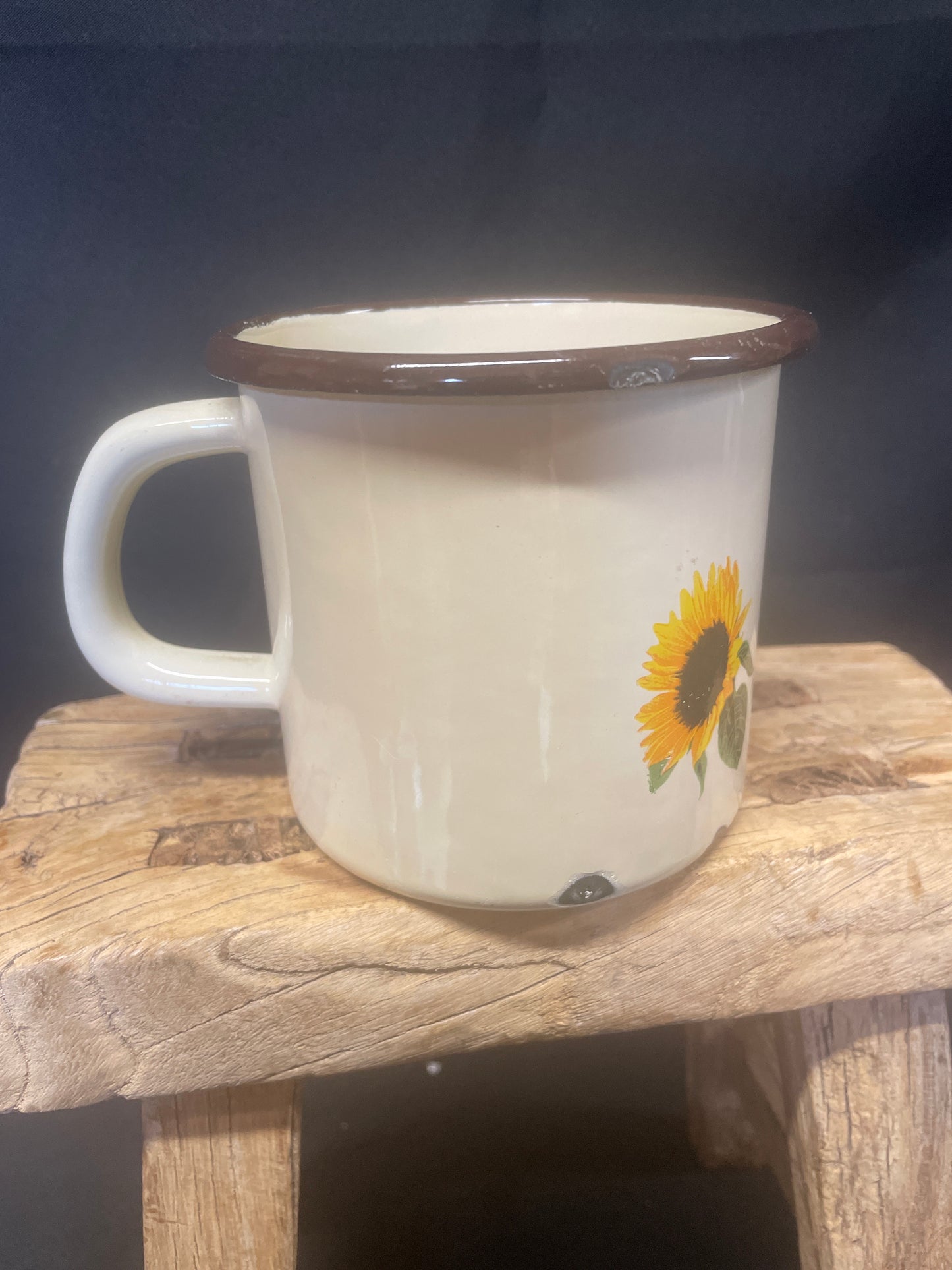 Large cream enamel mug with sunflowers decor.