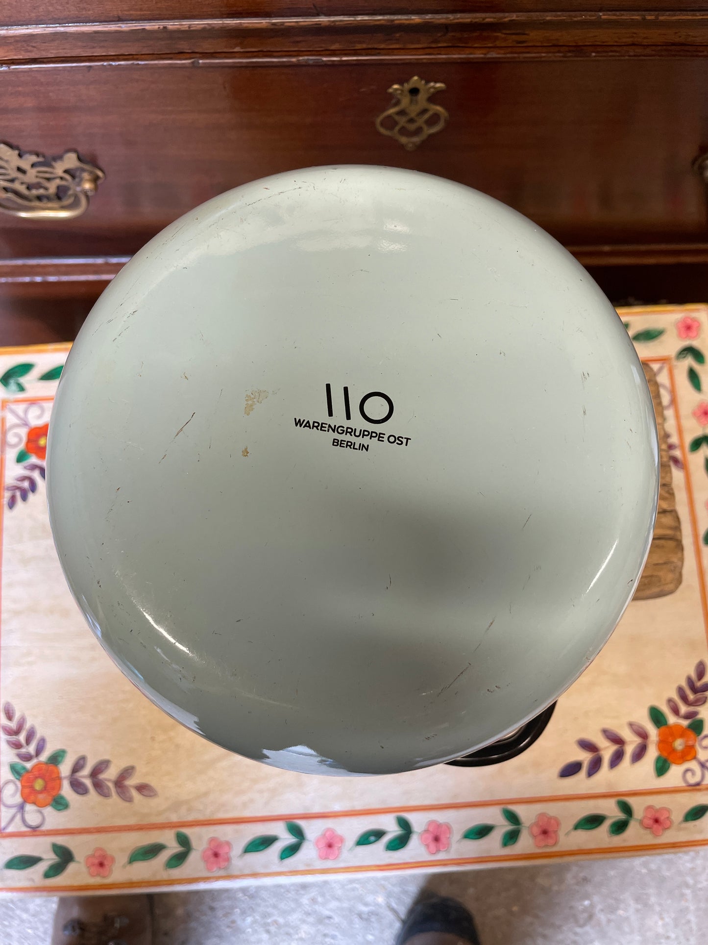 Pale blue enamel kettle with black handle and rim.