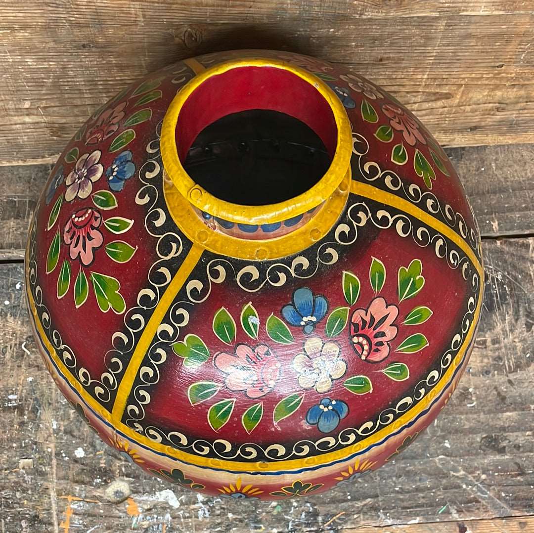 Indian hand crafted and painted decorative traditional metal water pot viewed from top.