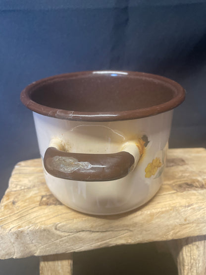 Enamel small two handled cooking pot cream and brown with floral design.