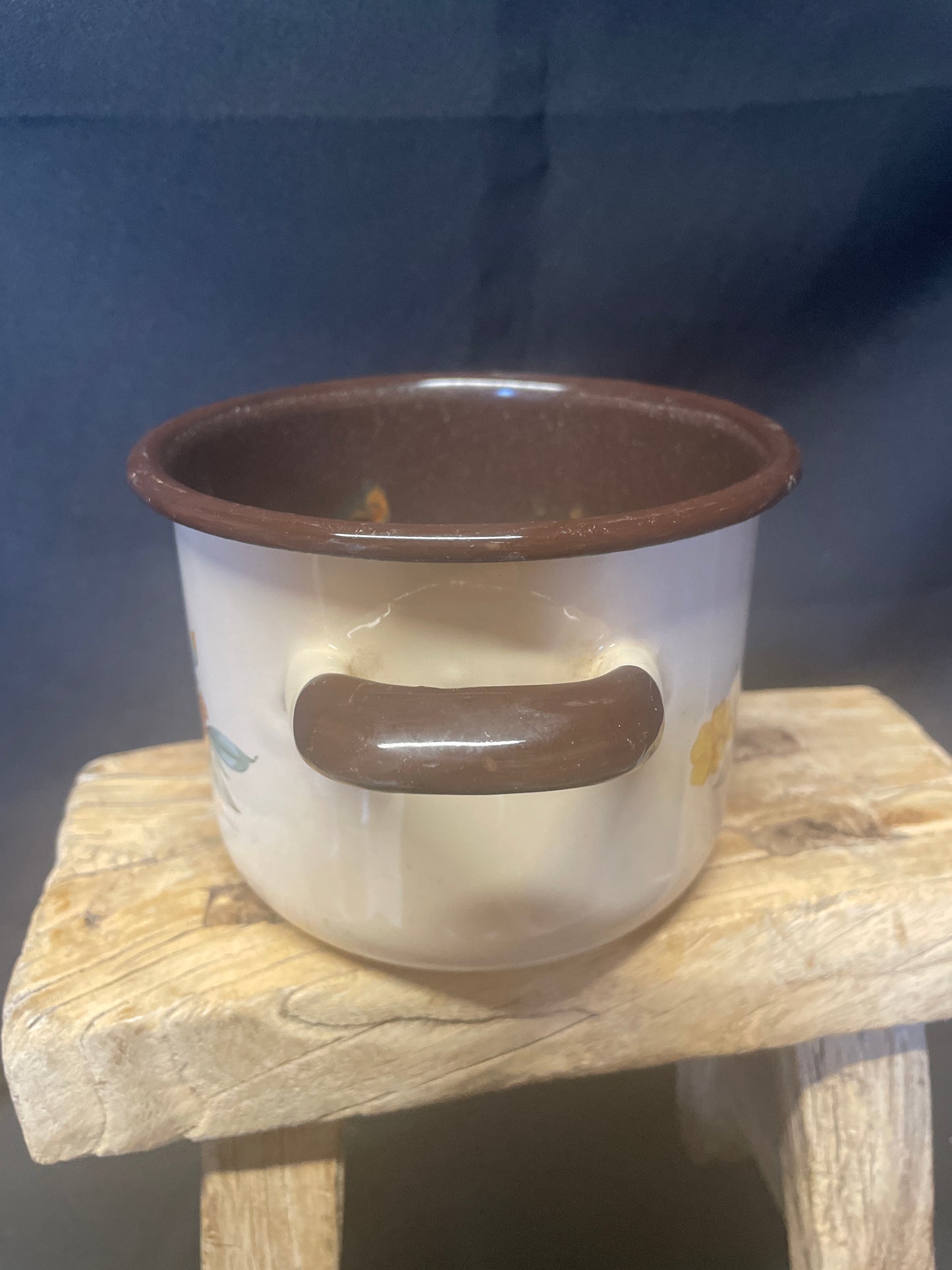 Enamel small two handled cooking pot cream and brown with floral design.