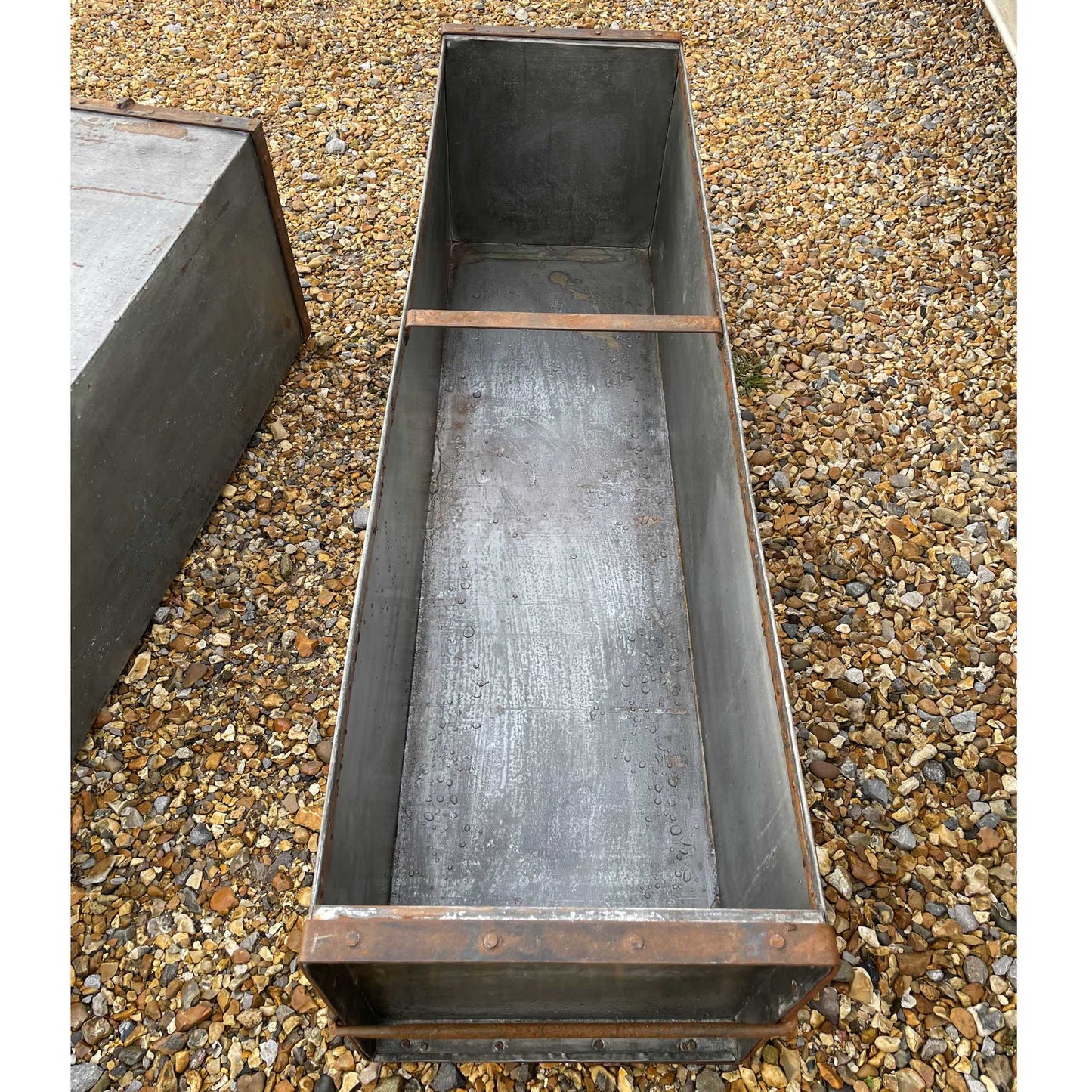 Large metal rectangular trough planter.
