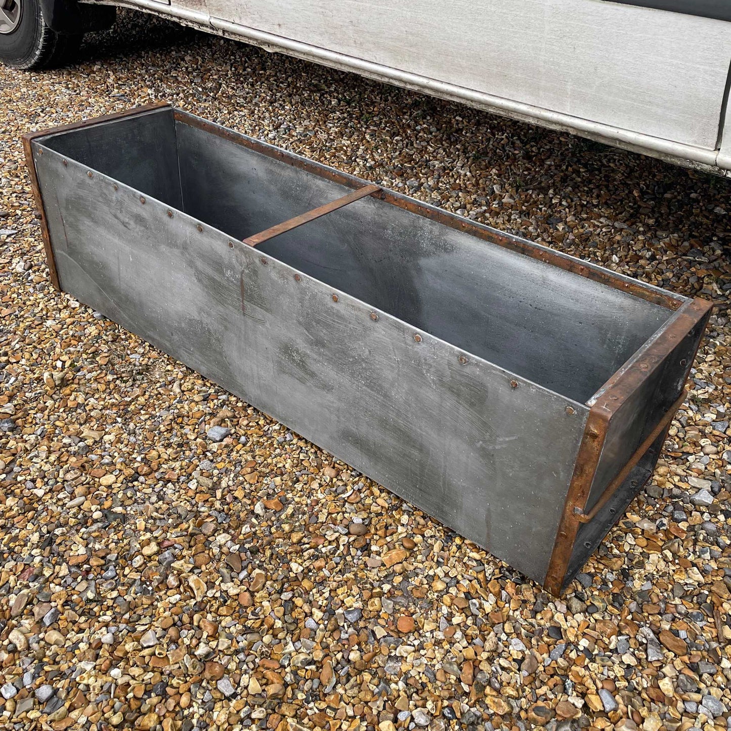 Large metal rectangular trough planter.