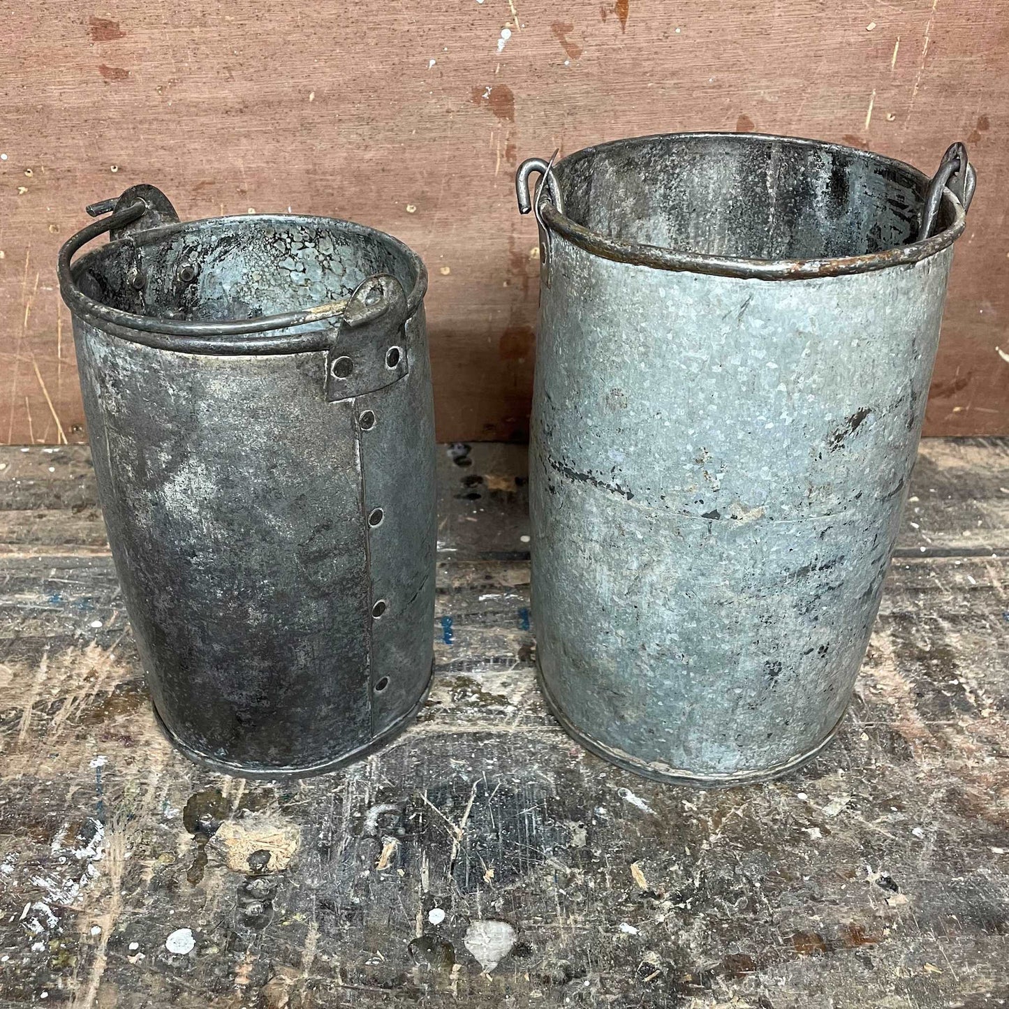 Metal planter bucket with handle.