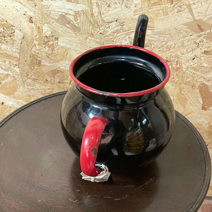 Black enamel tea pot without lid.