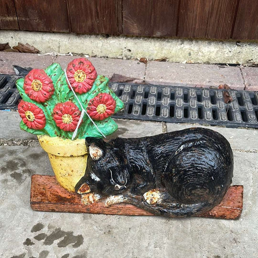 Cast iron cat and flower pot door stop.