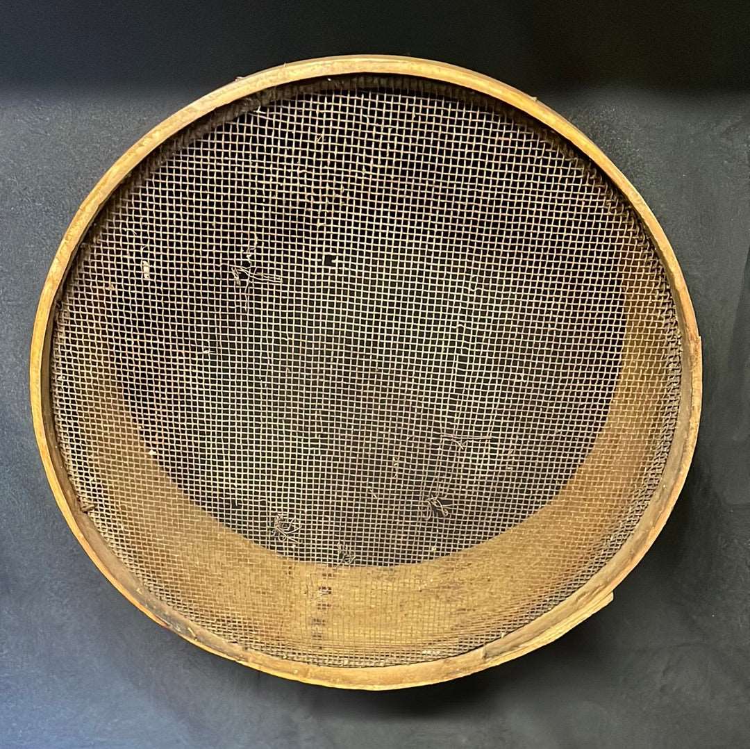 Vintage wooden sided grain sieve.