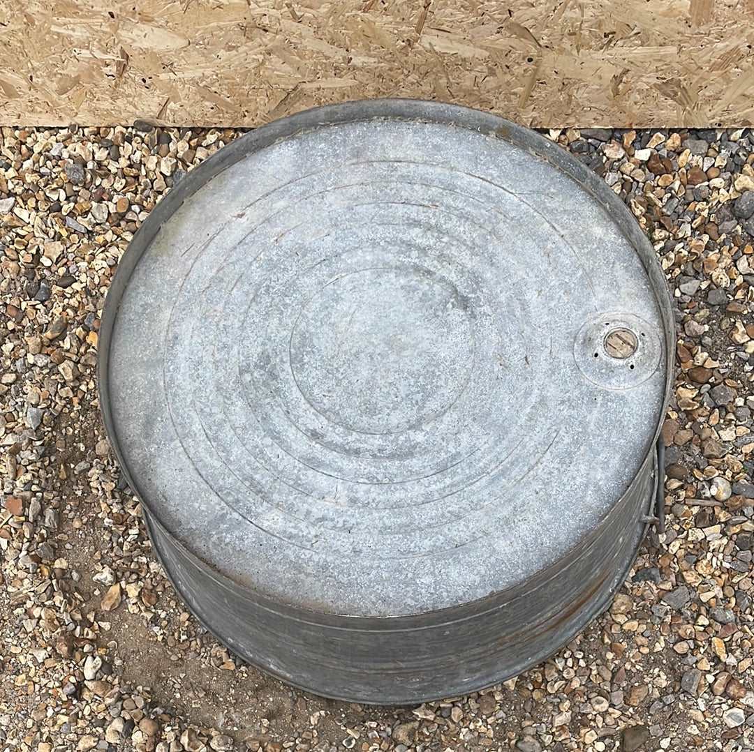 Round straight sided shallow galvanised tub planter with two handles.