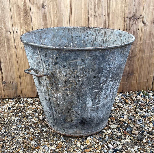 Taper sided two handled rustic galvanised bin garden planter container.