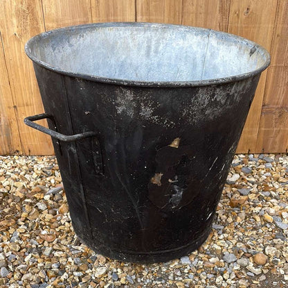 Tapered sided rustic galvanised two handled bin garden planter aged black paint.