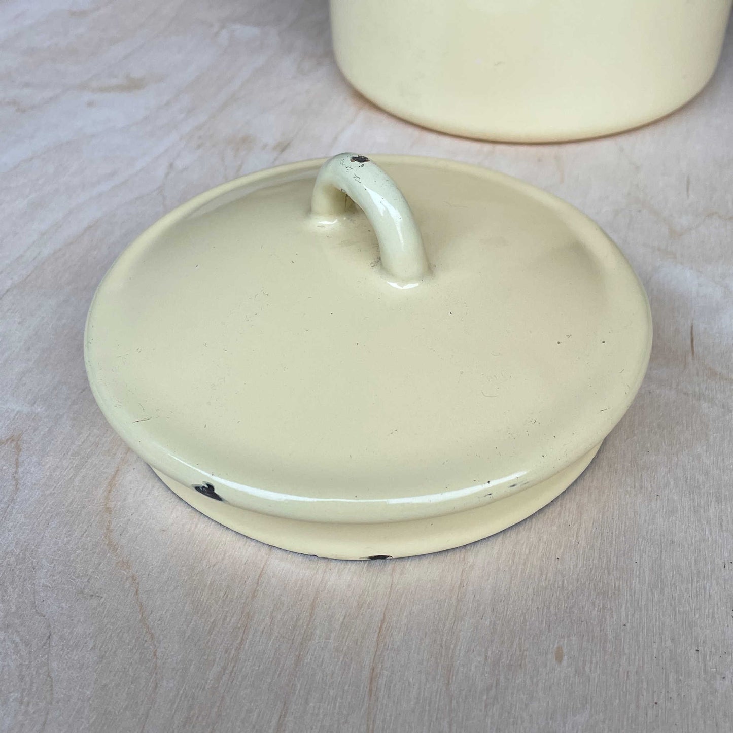 Cream enamelled churn container with lid.